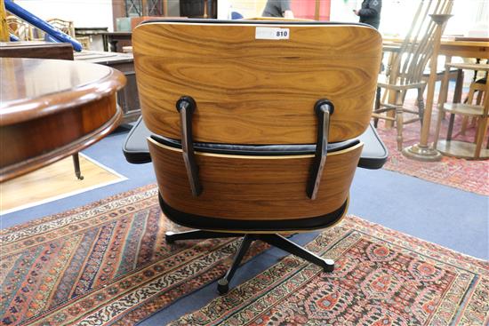 A reproduction Eames chair and stool